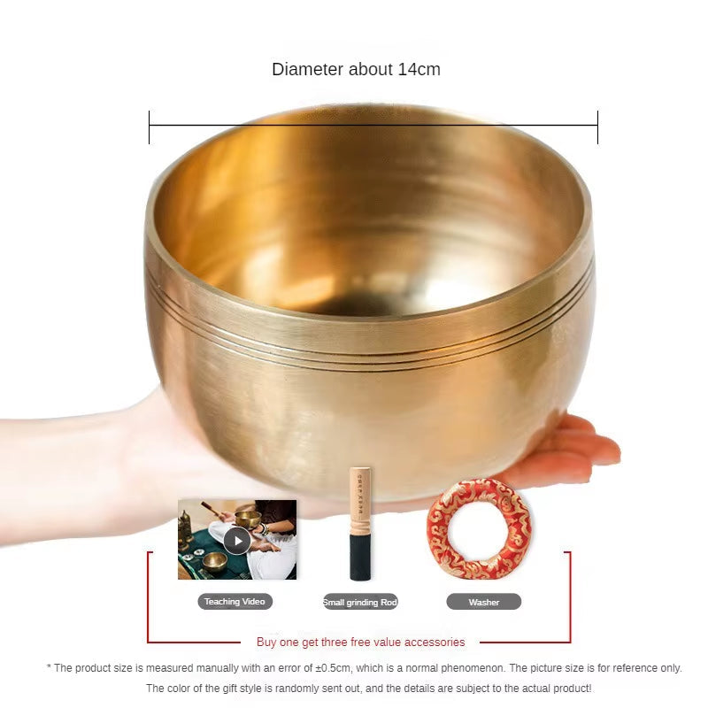 Golden Tibetan singing bowl with grooves for meditation and healing in a set