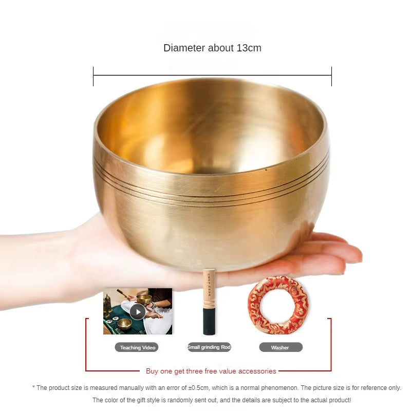 Golden Tibetan singing bowl with decorative grooves for meditation and healing