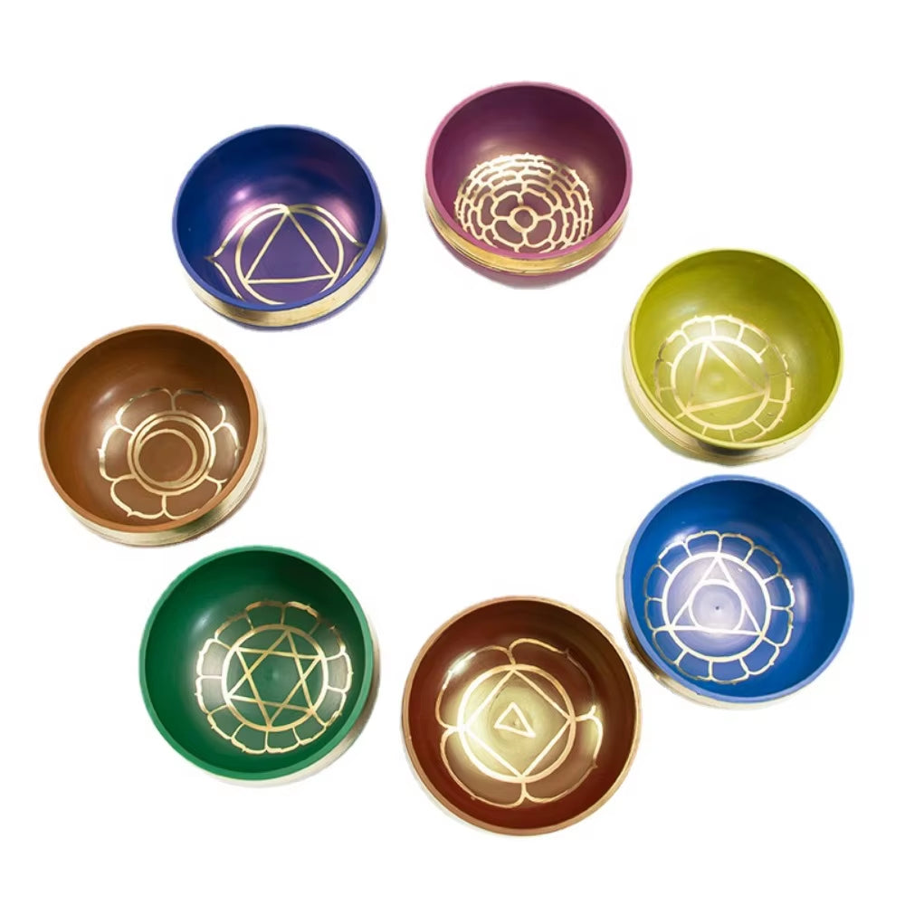 Seven colorful bowls with chakra symbols in Tibetan Singing Bowl Set for healing