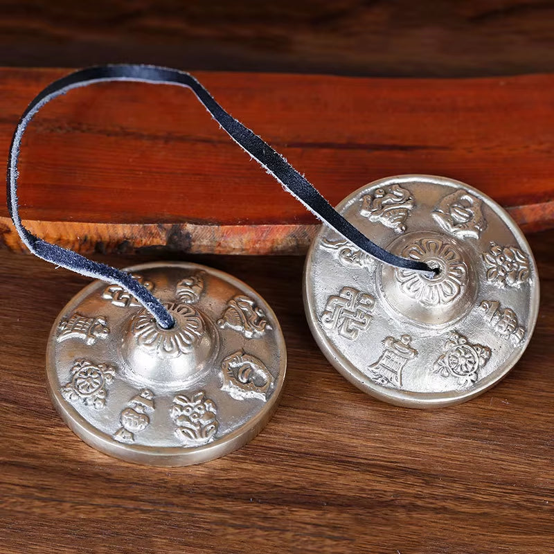 Tibetan meditation tingsha cymbals with blue cord for yoga and mindfulness practices