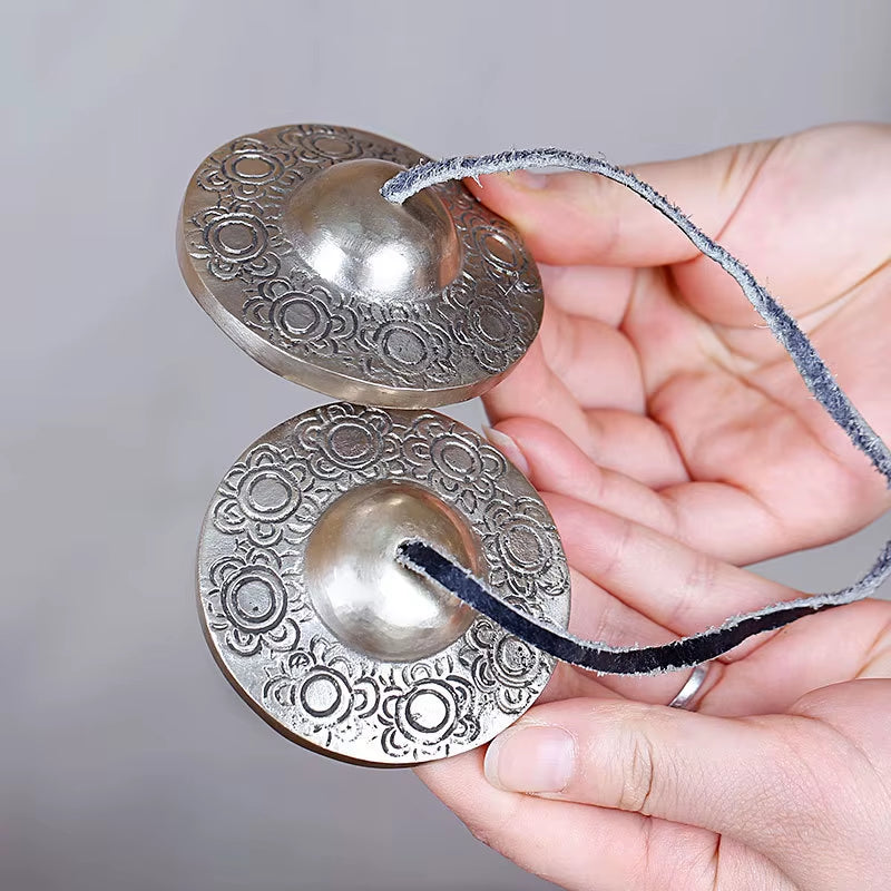 Decorative metal Tibetan Tingsha hand cymbals with floral engravings for meditation