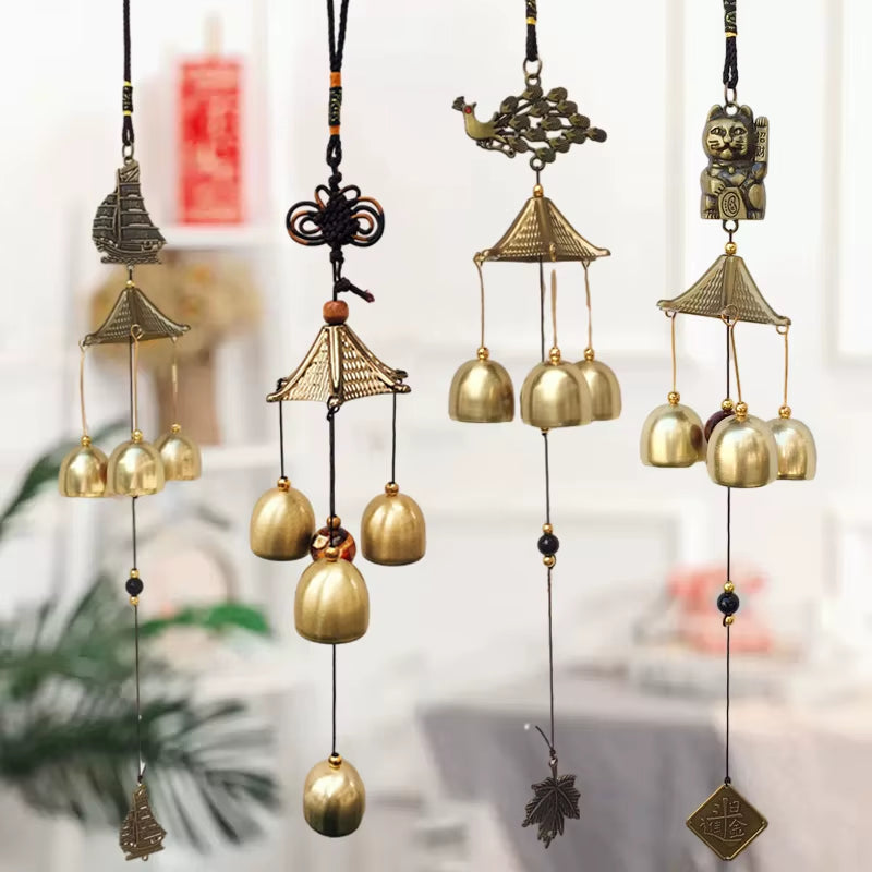 Decorative brass wind chimes with golden bells in vintage pagoda-style design