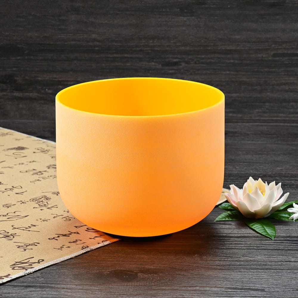 Orange frosted crystal singing bowl with yellow interior for Solar Plexus Chakra healing