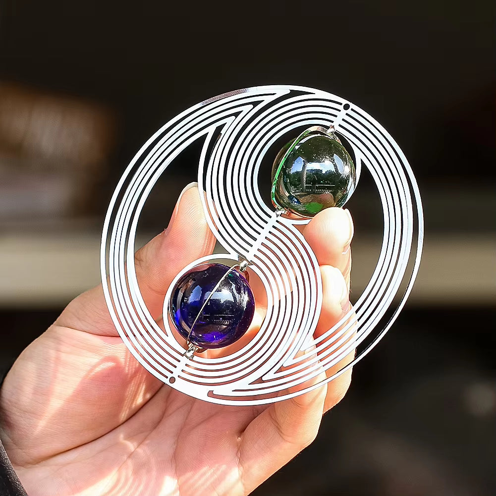 Spiral glass sculpture with colored marbles in Yin Yang Kinetic Metal Wind Spinner Garden